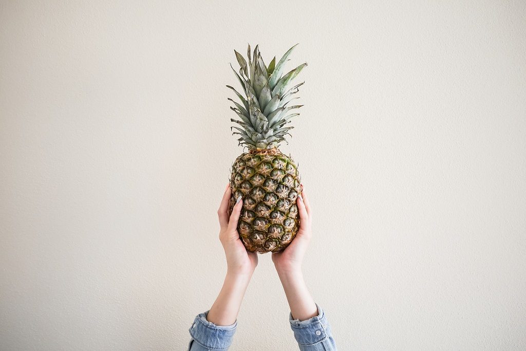 Fresh Ananas in Female Hands